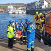 RNLI and Coastguard teams help transfer a woman to an ambulance at Seahouses harbour. Picture: Seahouses RNLI