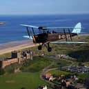Weather permitting, a World War II vintage Tiger Moth plane will fly over Bamburgh Castle on June 8 at around 11am. Picture: PA Images/ Alamy