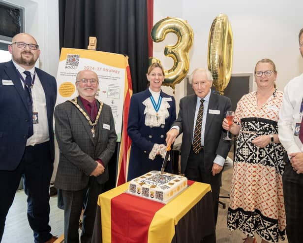 Founder charity trustee and former DCHS headteacher Roy Todd is pictured cutting the celebration cake with co-headteachers James Wilson and Alan Rogers, High Sheriff of Northumberland Lucia Bridgeman, Mayor Geoff Watson and BOOST chair Katherine Williams. Picture: Jane Coltman