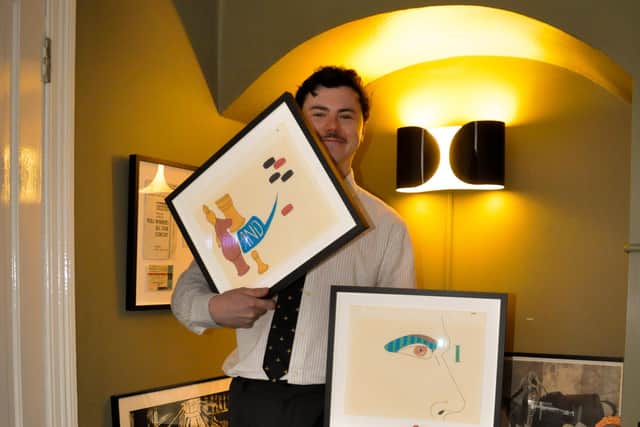 Joseph Robert O'Donnell holding the rare drawings created by John Lennon and Stephen Verona.