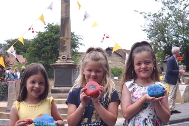 Missy Rose (6), Georgia Youll (8) and Alexa Joy (8) are pictured with tribute stones laid at the service.