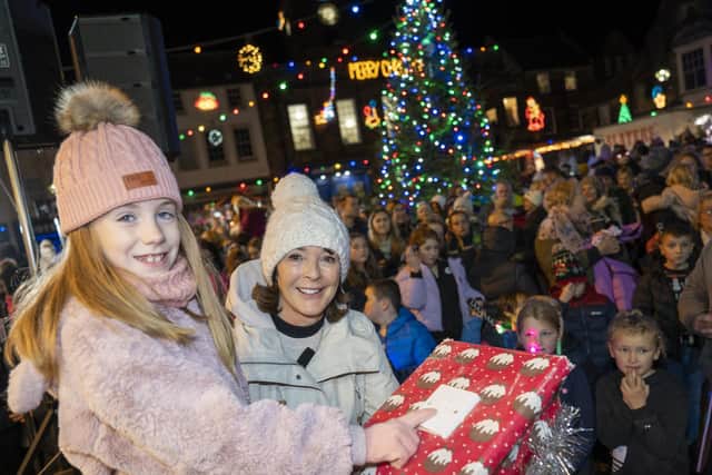 Millie Rae O’Neill switches on the Alnwick lights in 2022 watched by the Duchess of Northumberland. Picture: Jane Coltman