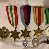 The memorabilia includes medals and other items.