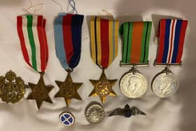 The memorabilia includes medals and other items.