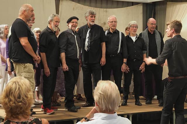 Members of the Voicemale choir in full voice.