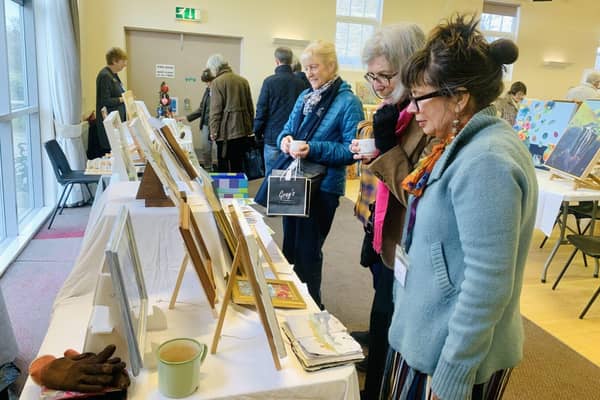 Art is meant to be shared! Visitors admiring paintings at Morpeth Art Group