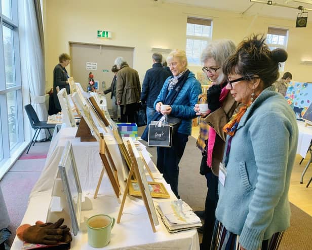 Art is meant to be shared! Visitors admiring paintings at Morpeth Art Group