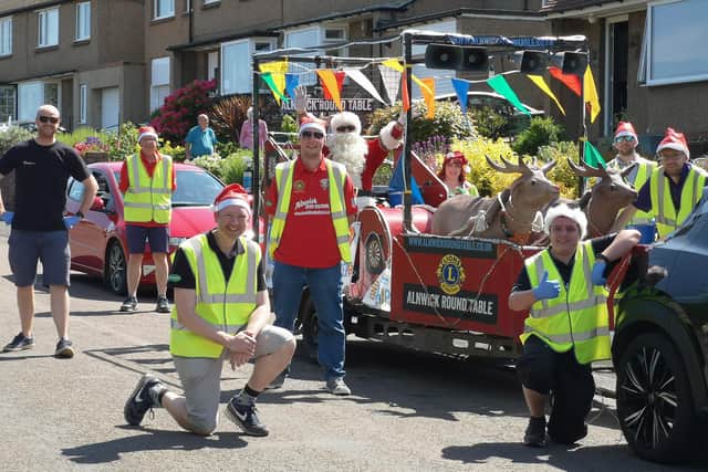 Father Christmas and his socially-distanced helpers from Alnwick Round Table toured Alnwick and district over the weekend where they invited people to clear out their cupboards and donate to the NHS, Alnwick District Food Bank and Alnwick Lions. Picture by Jane Coltman.
