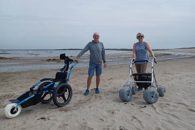 Donors Rob Racenis and Katie Steele with the beach wheelchairs
