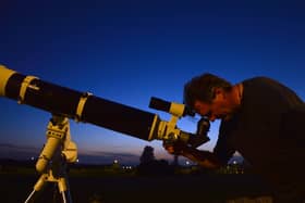 Presenter David Hughes with his telescope.