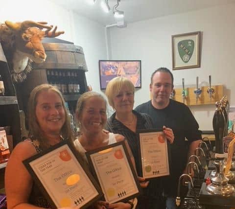 Left to right, The Office team Gillian North, Natalie Grenfell and landlady Andrea Johnson with CAMRA branch chairman Paul Hillhouse.