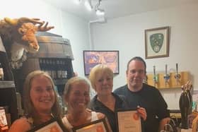 Left to right, The Office team Gillian North, Natalie Grenfell and landlady Andrea Johnson with CAMRA branch chairman Paul Hillhouse.