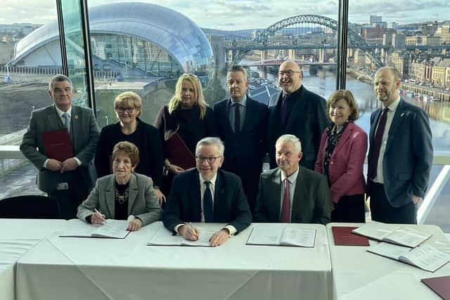 Michael Gove signs the devolution deal, flanked by local leaders including Coun Tracy Dixon (back row, second left), Coun Graeme Miller (back row, fifth left) and Coun Glen Sanderson (front right)