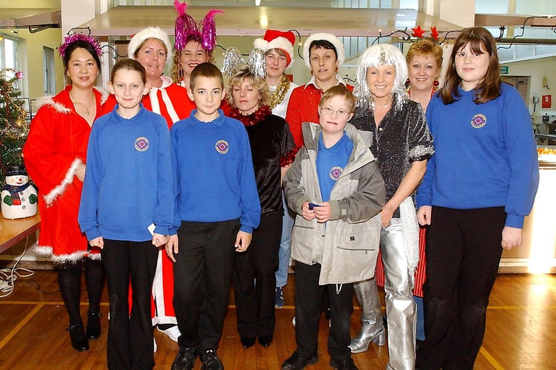 Kitchen staff from Lindisfarne Middle School, Alnwick, dress up for the pupils' Christmas dinner in December 2003.