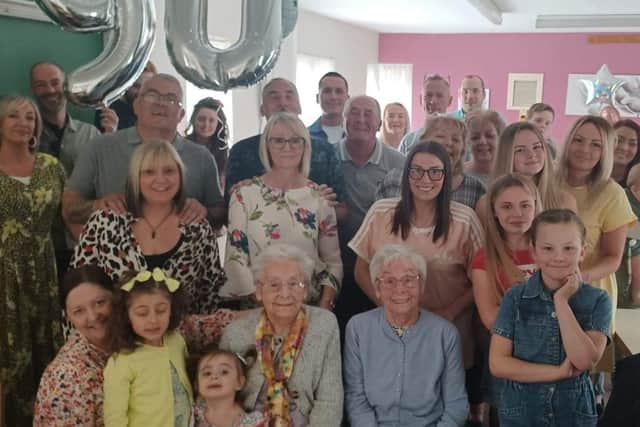 Lilian Ness (right) and her twin sister Maureen McDade are joined by family to celebrate their 90th birthday.