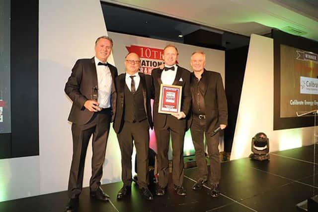 Gary Matthews, managing director of Calibrate Energy, left, and Jack Smales, technical sales manager, second from right, who were presented the award by Bobby Davro.
