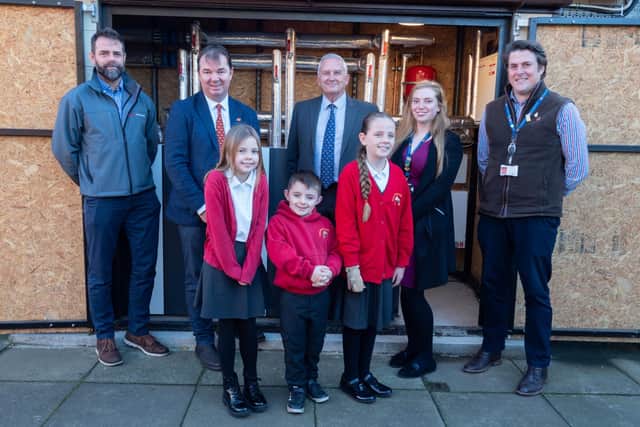 Guy Opperman, Coun Glen Sanderson, other Northumberland County Council representatives, a Kensa Contracting representative and children from Stamfordham Primary School. Picture by Ivor Rackham.