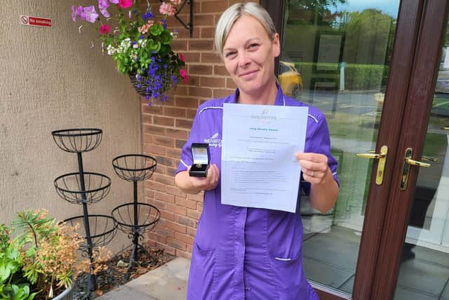 Housekeeping assistant Joanne Long has been honoured for 10 years' service