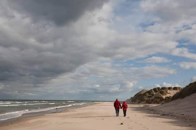 Walkers on a north Northumberland beach. Picture: Bruce Cutts/Natural England