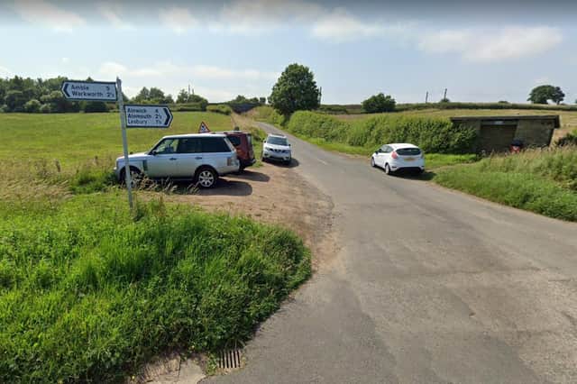 Cars parked on verges by the junction at High Buston.