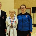 Jay Crosby shows off his bronze medal with club instructors Dylan and Gemma Gibson.