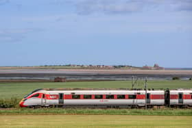 An LNER Azuma train travelling past Holy Island.