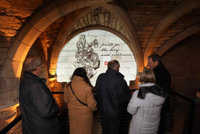 Visitors view the installation in the St Aidan's Church ossuary.