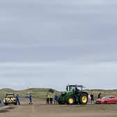 A vehicle that became stuck on the Holy Island causeway after driving onto soft sand is rescued by a local farmer. Photo: Colin Hardy.