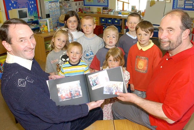 David Dickinson, Alan Stripp and pupils of Netherton First School pictured in May 2004 with a book in memory of late headteacher Kay Stripp.