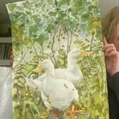 Mary Ann Rogers holding a watercolour she painted exclusively for Tynedale Hospice at Home to raffle earlier this year.