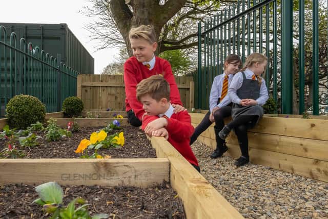 Students from St Bede's inspect their new memorial garden.