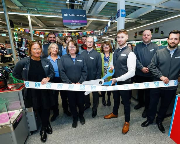 Store manager Jordon Dixon, with his team, cuts the ribbon at the new Co-op store in Rothbury. Picture: John Millard