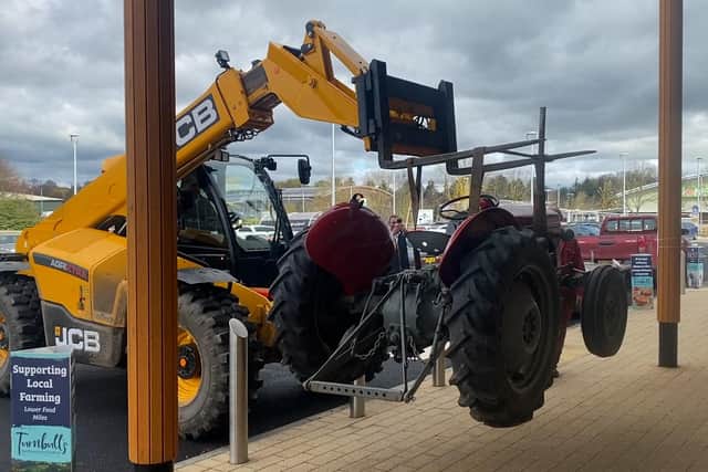The tractor is lifted into place.