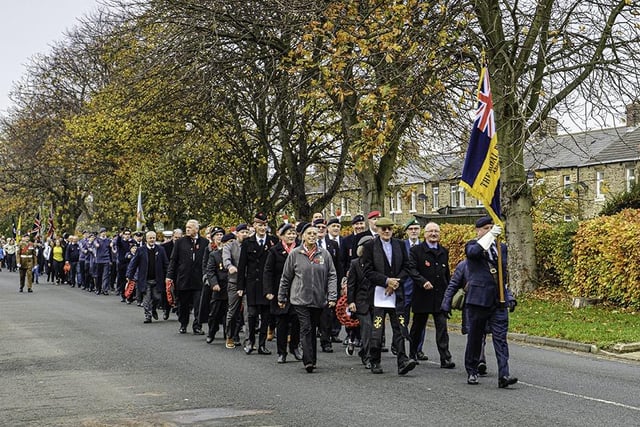 The parade makes its way through town, led by the local branch of the Royal British Legion.