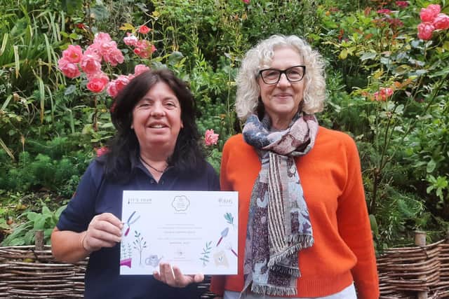 Kate Dixon and Jackie Kaines Lang with the It’s Your Neighbourhood certificate.