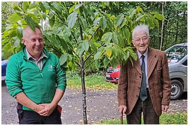 Alex MacLennan and Arthur at the Sweet Chestnut tree that was planted on in Swarland.