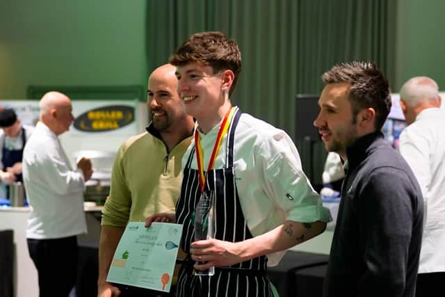 A delighted Sam Eke receives his Young Chef of the Year certificate and trophy.