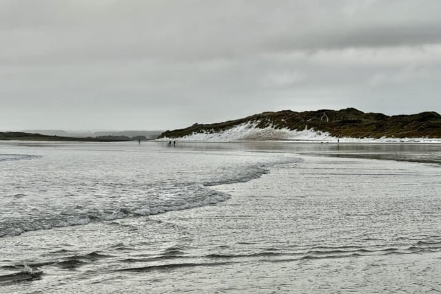 Snow has landed on the sandy stretch of beach at Beadnell.