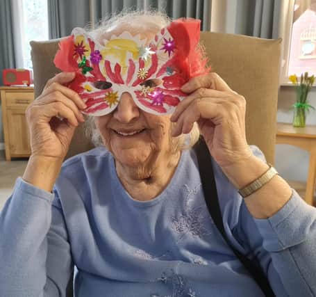 The Oaks Care Home resident Florence Cole, 94, with her handmade Mardi Gras mask for the party.
