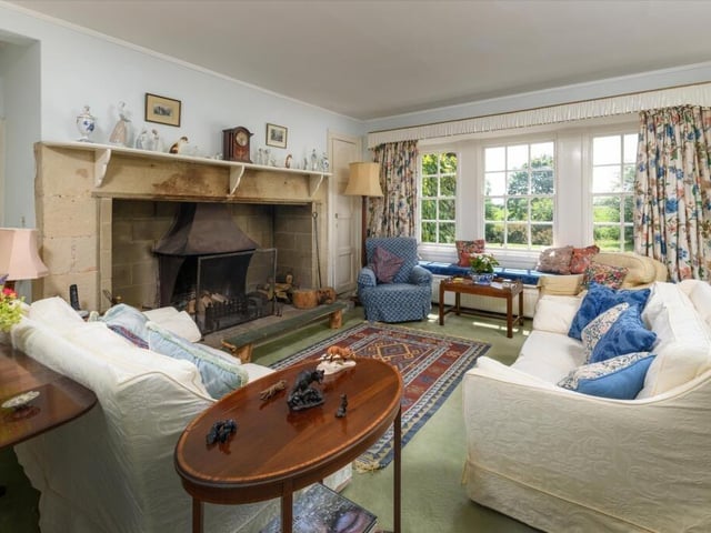 The drawing room is centred around a substantial sandstone fireplace.