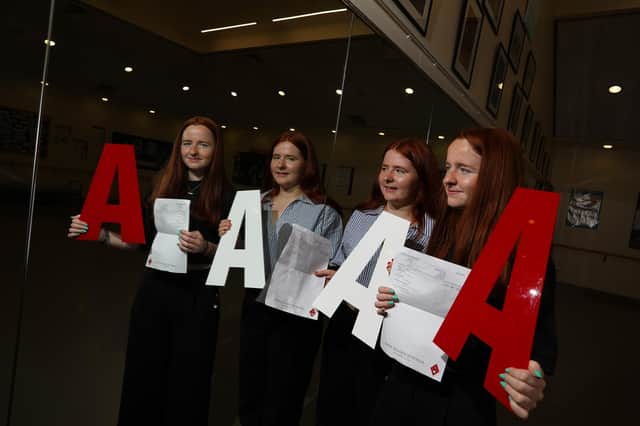 Twins Emily and Libby Doughty celebrate identical results