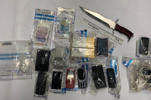Drugs believed to be heroin, a machete, cash and mobile phones were recovered during the dawn raid.
