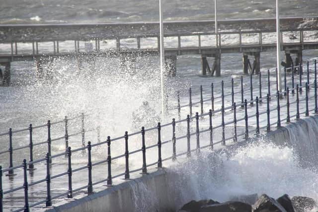 A photo taken by a member of the public and shared by Amble Coastguard Rescue Team with permission after a scooter rider was spotted out riding through the waves of the South Pier breakwater.