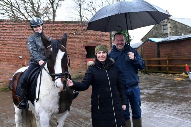 Lana Brown, Faye Allison, and Amethyst Homes managing director Richard Bass at the stables. (Photo by Amethyst Homes)
