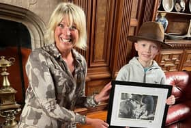 Bamburgh Castle's Claire Watson-Armstrong presents Indiana Jones fan Kit Matthews with a signed photo of Harrison Ford.