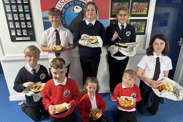 Pupils with their chip shop lunch from Lewis's.