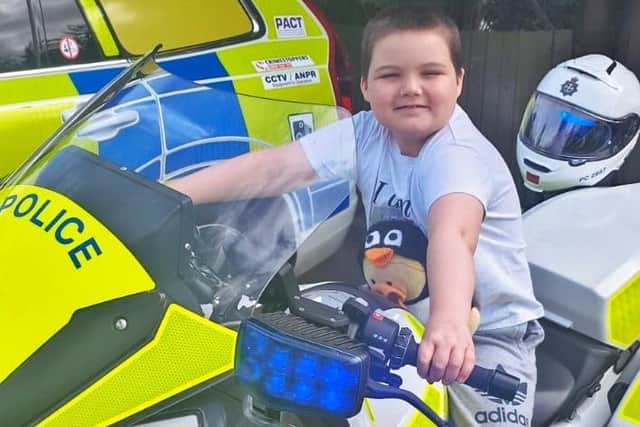 JoJo and his chemotherapy duck, Dave, on one of the police bikes.
