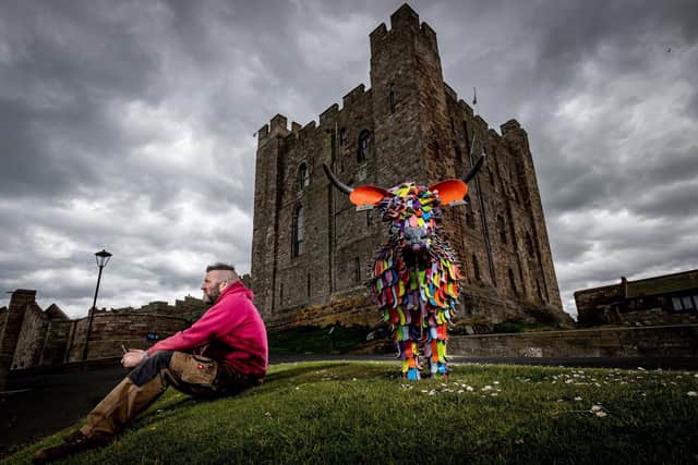 Kev Paxton with the Rainbow Cow called Florence at Bamburgh Castle that is too be auctioned in aid of NHS Charities Together. Picture: Charlotte Graham Photography