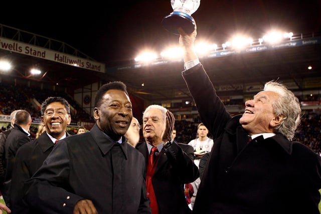 Pele watches as the President of Sao Paulo soccer club, Juvenal Juvencio, right, lifts a trophy which his under 17 side had won earlier in the day at Sheffield United's home ground of Bramall Lane (AP Photo/Simon Dawson)