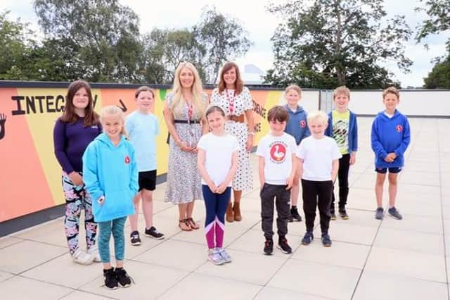 Sadie Rodway, blonde hair, and Nadine Fielding with a group of Morpeth First School pupils.